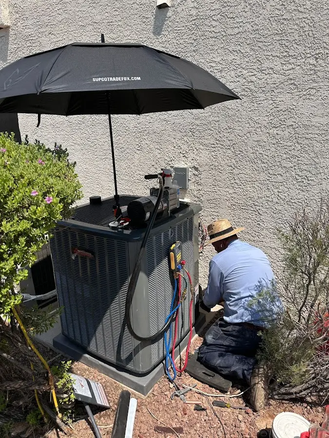 HVAC technician performing outdoor AC maintenance in Guttenberg